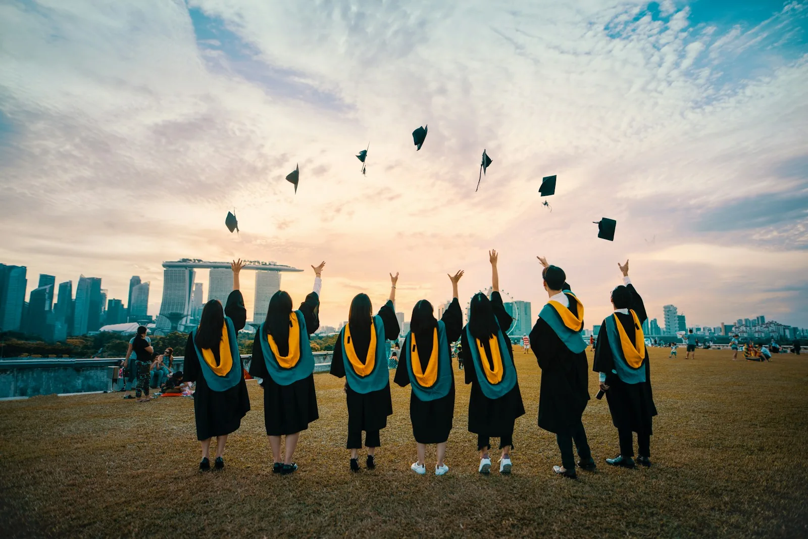 Graduates celebrating a new beginning against a city skyline
